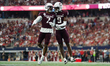 Texas A&M Aggies Moose #7 and Jahdae Walker #9 celebrate after a touchdown against the Ark...