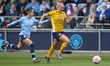 Pauline Bremer #8 of Brighton & Hove Albion W.F.C. is tackled by Yui Hasegawa #25 of Manch...
