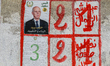 An election poster of the presidential candidate Kais Saied is pasted on a wall along a st...