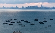 Fishing boats return to the coast of Gujia Island, a new area on the west coast of Qingdao...