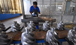 A worker works at an auto gear manufacturing company in Qingzhou Economic Development Zone...