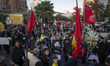 An Iranian protester carries a portrait of Islamic Revolutionary Guard Corps' (IRGC) Quds...