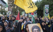 A veiled Iranian protester shouts anti-Israeli and anti-U.S. slogans while carrying a port...