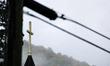 A church steeple rises in front of evening fog in Lansing, North Carolina on September 30,...