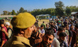 An Indian policeman stands guard at a polling station during the third and final phase of...