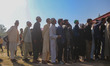 Voters queue to cast their ballots at a polling station during the third and final phase o...
