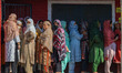 Women voters queue to cast their ballots at a polling station during the third and final p...