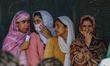 Women voters queue to cast their ballots at a polling station during the third and final p...