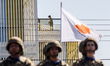A boy is seen on a building during the parade in Nicosia, Cyprus, on October 1, 2024. A mi...