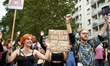 A protester holds a placard reading 'Every police is good to write ACAB'. It is a play on...