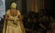Models present a creation by Indian designer Manish Malhotra to showcase the Handloom Indi...
