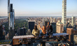 Tourists sit on The Beam recreating  a famous photograph 'Lunch Atop a Skyscraper' by Char...