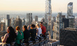 Tourists sit on The Beam recreating  a famous photograph 'Lunch Atop a Skyscraper' by Char...