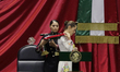 Claudia Sheinbaum (off-white dress), president of Mexico, receives the presidential sash i...