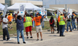 Dockworkers and their supporters hold signs during a strike outside the Bayport Container...