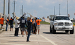 A passing driver holds up his fist in solidarity with a group of striking dockworkers outs...