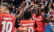 Victor Boniface of Bayer 04 Leverkusen celebrates with teammates after scoring a goal, whi...