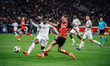 Florian Wirtz of Bayer 04 Leverkusen and Emerson of AC Milan are in action during the UEFA...