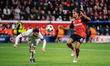 Amine Adli of Bayer 04 Leverkusen and Theo Hernandez of AC Milan are in action during the...
