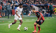 Samuel Chukwueze of AC Milan and Alejandro Grimaldo of Bayer 04 Leverkusen are in action d...