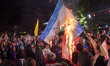 Iranian protesters shout anti-Israeli slogans while burning an Israeli flag in a celebrati...