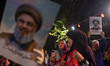 Iranians hold portraits of Lebanon's Hezbollah Secretary General, Hassan Nasrallah, who wa...