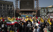 Iranian people wave flags of Lebanon's Hezbollah and Iranian flags during a gathering mark...