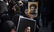Veiled Iranian women hold portraits of Lebanon's Hezbollah Secretary General Hassan Nasral...