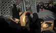 Veiled Iranian women hold portraits of Lebanon's Hezbollah Secretary General Hassan Nasral...