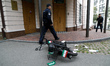 A moped with stickers in the form of the flag of the Islamic Republic of Iran, on which on...