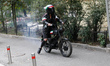 A Femen activist heads towards the Embassy of Iran on a moped to take part in a protest ag...