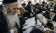 Orthodox Jewish pilgrims pray near the tomb of Rabbi Nachman while celebrating Rosh Hashan...