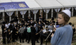 Children Orthodox Jewish pilgrims pray near the tomb of Rabbi Nachman while celebrating Ro...