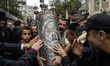 Ultra-Orthodox Jewish pilgrims carry the Torah near the tomb of Rabbi Nachman while celebr...