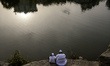 Ultra-Orthodox Jewish pilgrims pray on the bank of a lake near the tomb of Rabbi Nachman w...