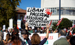 A protester holds a placard reading 'Lebanon, Palestine, resistance to the Israeli occupat...