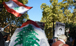 A protester is wrapped in a Lebanese flag. Hundreds of people demonstrate in Toulouse, Fra...