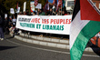 The banner reads 'Solidarity with the Palestinian and Lebanese people'. Hundreds of people...