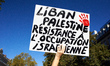 A placard reads 'Lebanon, Palestine, Resistance to the Israeli occupation'. Hundreds of pe...
