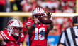 Wisconsin Badgers quarterback Braedyn Locke #18 takes a snap against the Purdue Boilermake...