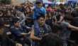 A young man carries his son during a concert to mark the 44th anniversary of the Tianguis...