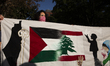 A person poses for photographs during a pro-Palestinian rally as part of an international...