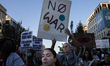 A person holds a sign with the text ''No war'' during a pro-Palestinian rally as part of a...