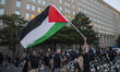 A demonstrator waves a Palestinian flag during a pro-Palestinian rally as part of an inter...