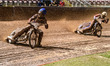 Freddy Hodder of Belle Vue Colts in blue leads Stene Pijper of Sheffield Cubs in white dur...