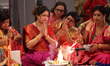 Bengali Hindu women perform prayers during the Durga Puja festival at a pandal (temporary...