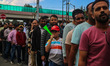People wait in queue to enter Bakshi Stadium during the Legends League Cricket match betwe...