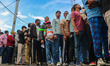 People wait in queue to enter Bakshi Stadium during the Legends League Cricket match betwe...