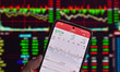 The day's stock index closing point appears on the mobile phone of a citizen in Fuyang, Ch...
