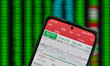 The day's stock index closing point appears on the mobile phone of a citizen in Fuyang, Ch...